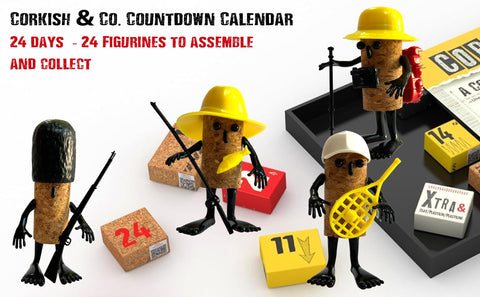 Assorted assembled Corkish figurines from THE PURPLE COW on a shelf adding personality to decor