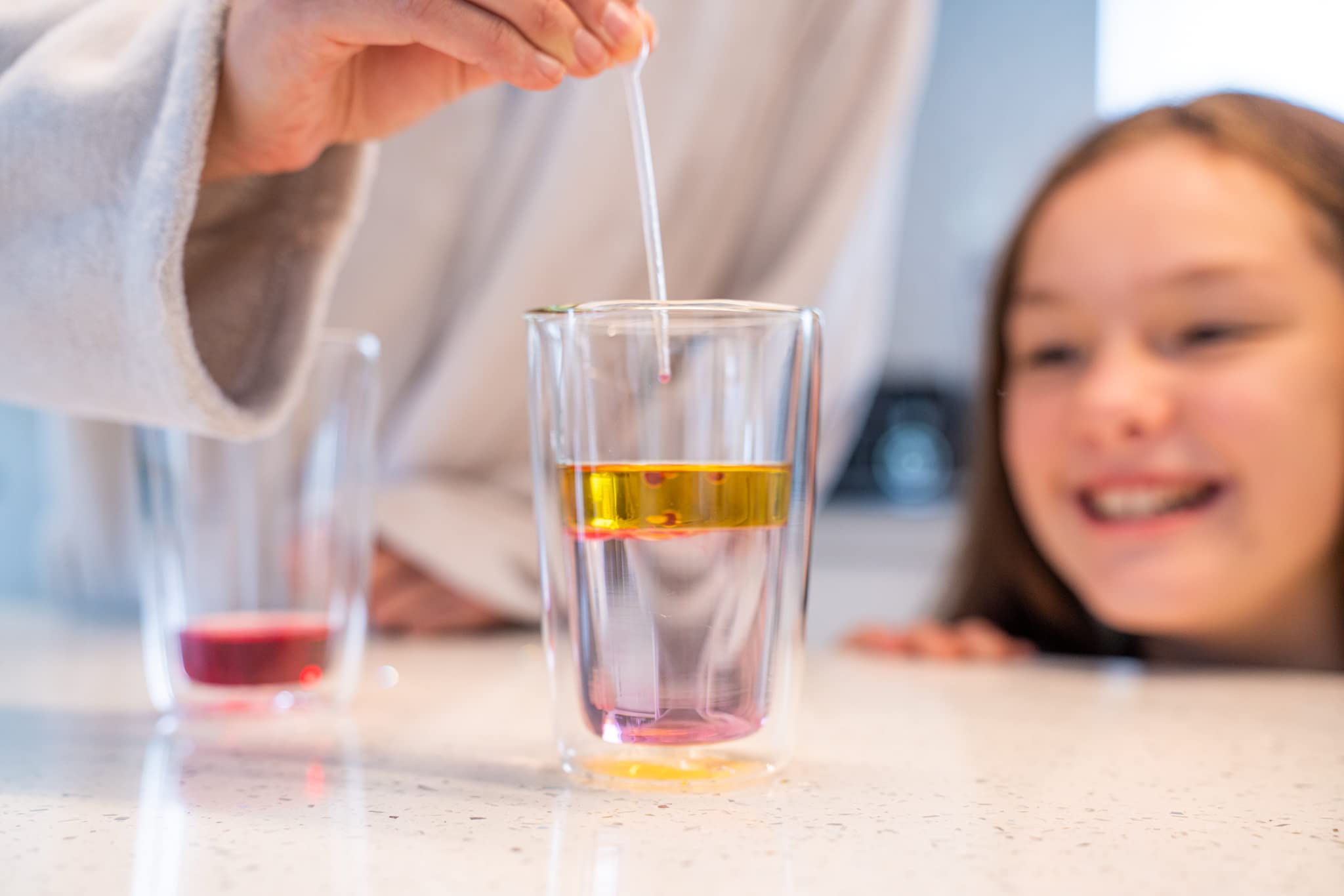 Child performing a Crazy Scientist experiment from The Purple Cow with parental supervision