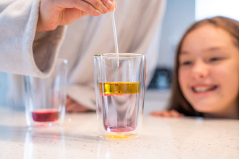 Child performing a Crazy Scientist experiment from The Purple Cow with parental supervision