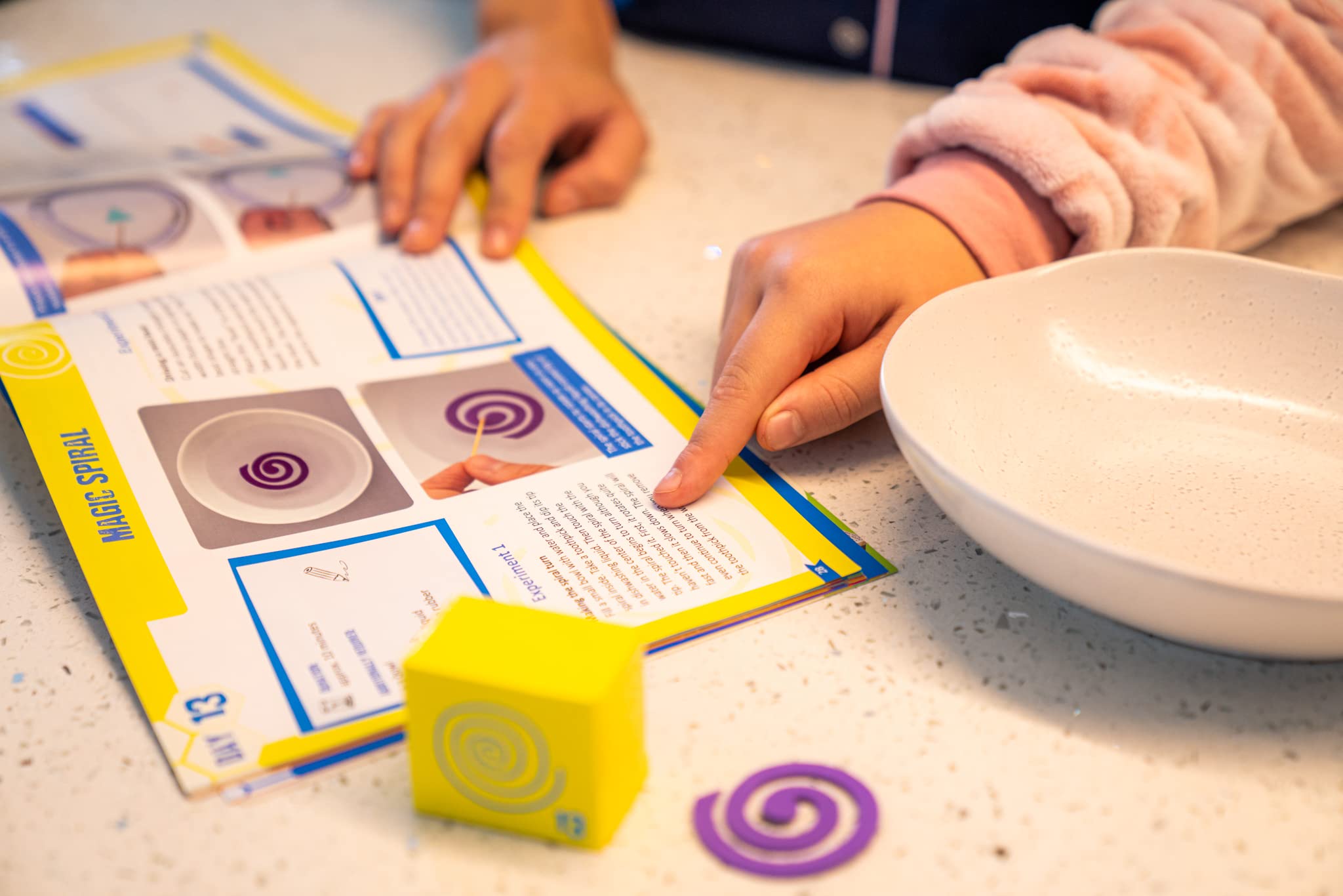 Hand holding a single calendar box to show The Purple Cow experiment size and scale