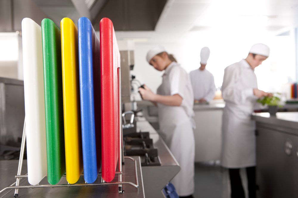 Thirteen Chefs board held in hand showing 18 x 12 inch size and portability benefit