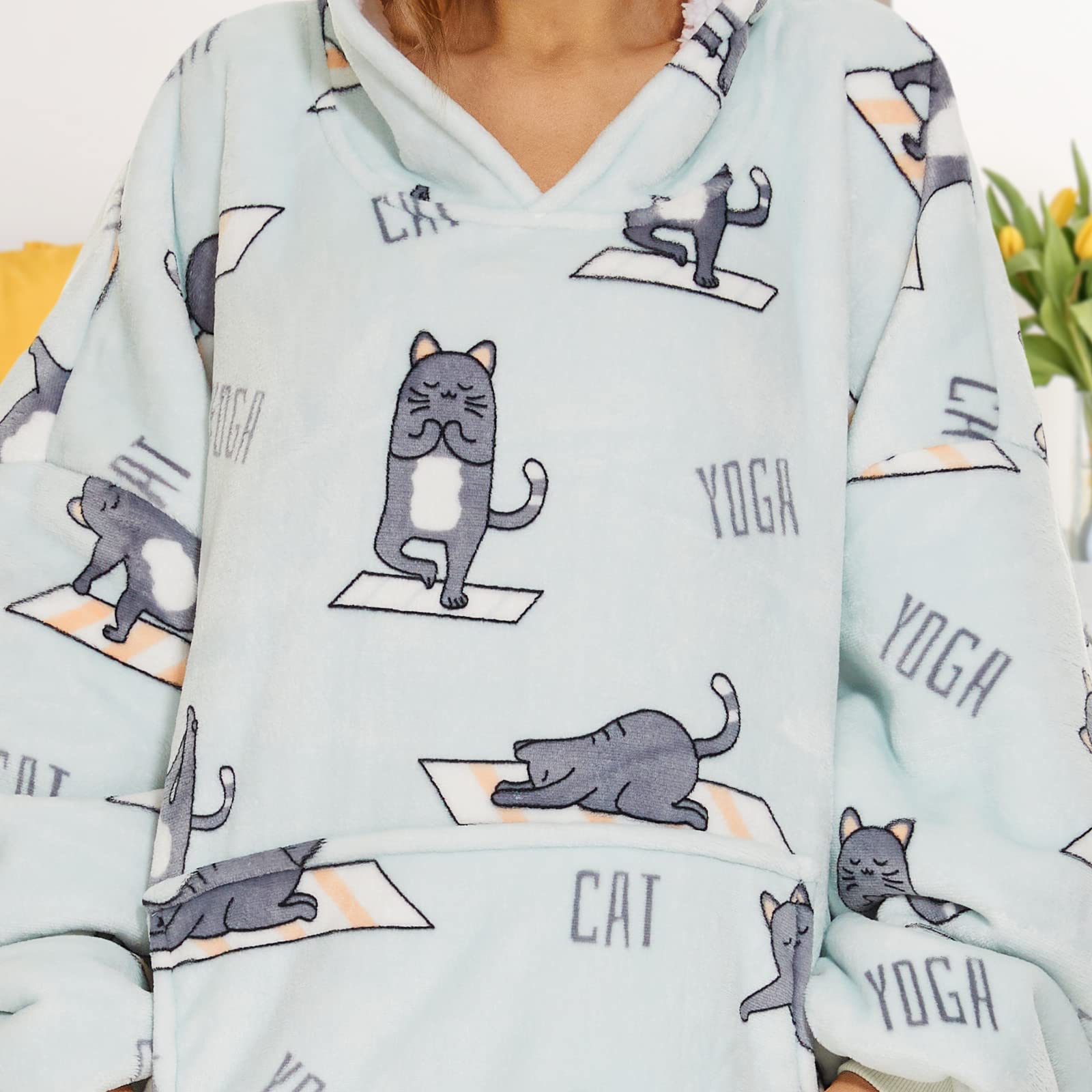 THREE POODLE hoodie on a chair showing scale and generous oversized length