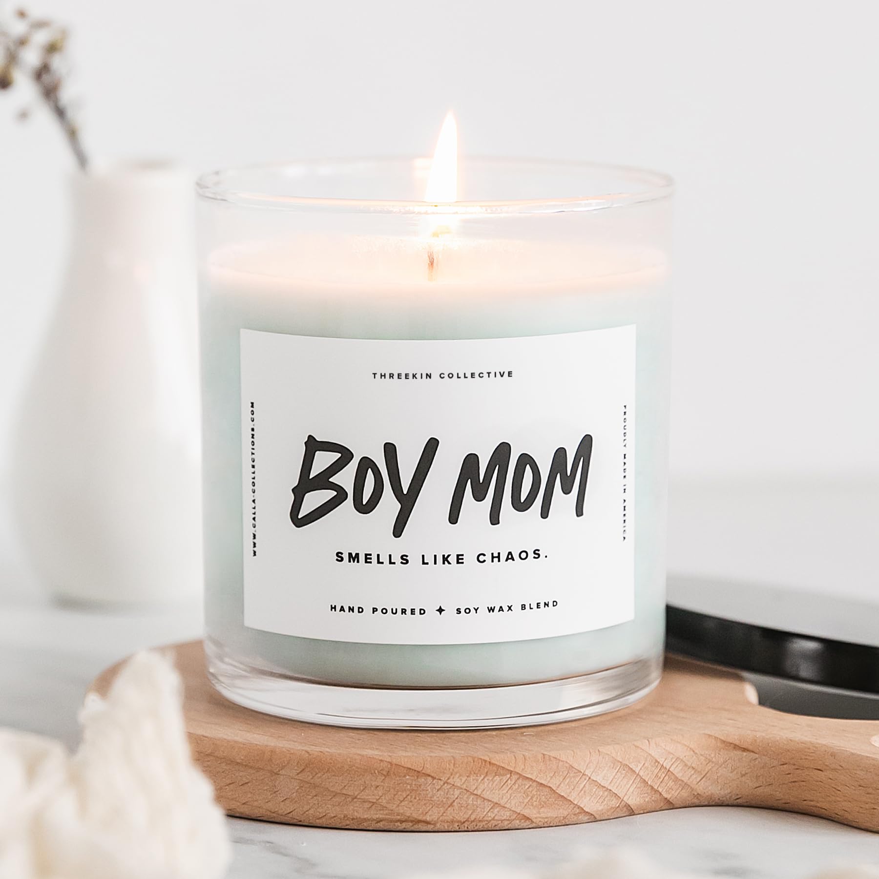 ThreeKin candle lit on a bedside table creating a relaxing atmosphere