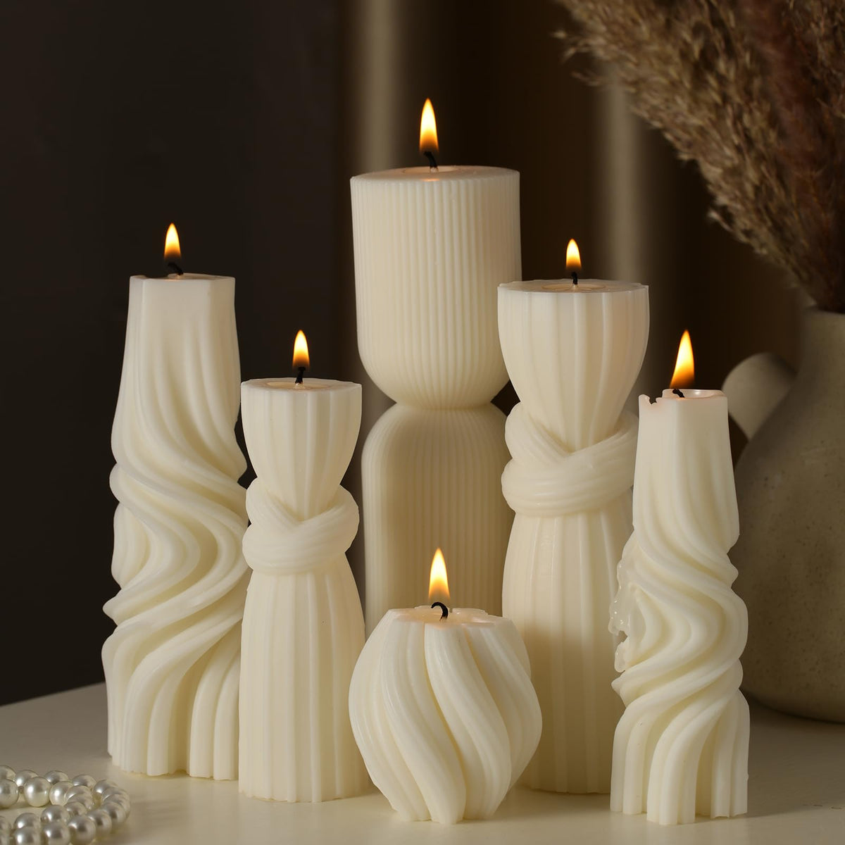 Threlaco front view of six white ribbed pillar candles showing set variety and styling benefit