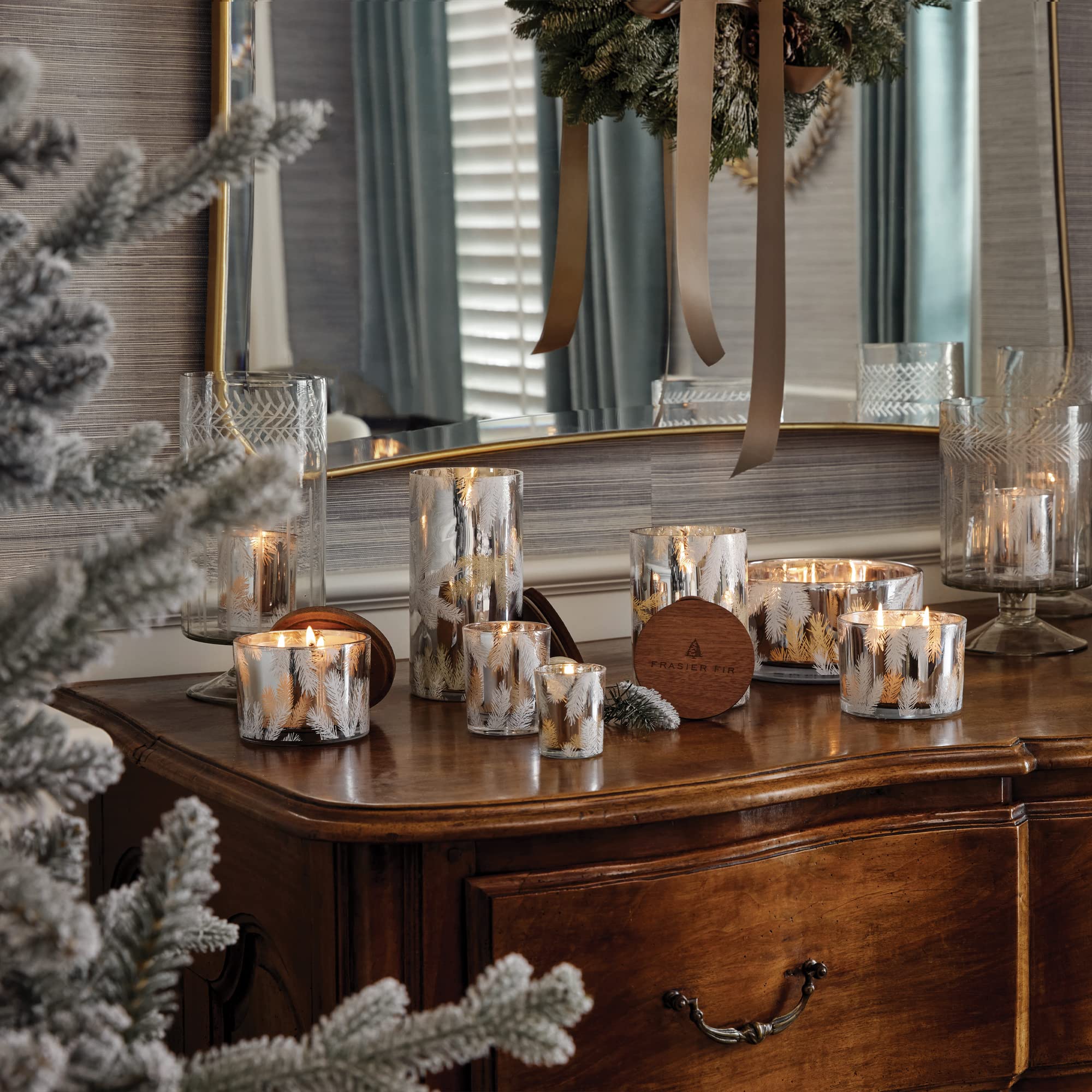 Thymes Frasier Fir candle in cozy living room, creates warm ambiance