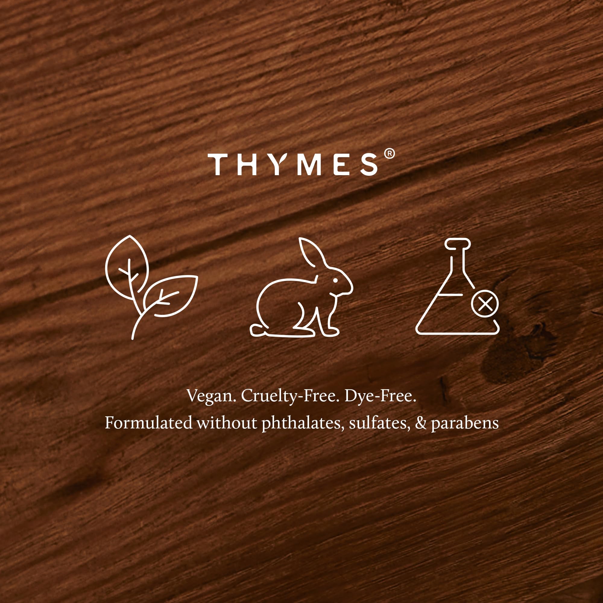 thymes candle placed near a fireplace creating cozy fall ambiance in room