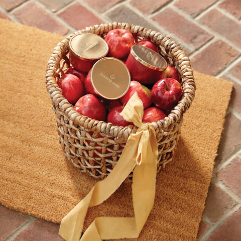 Thymes tin next to autumn decor suggesting seasonal, cozy home scent