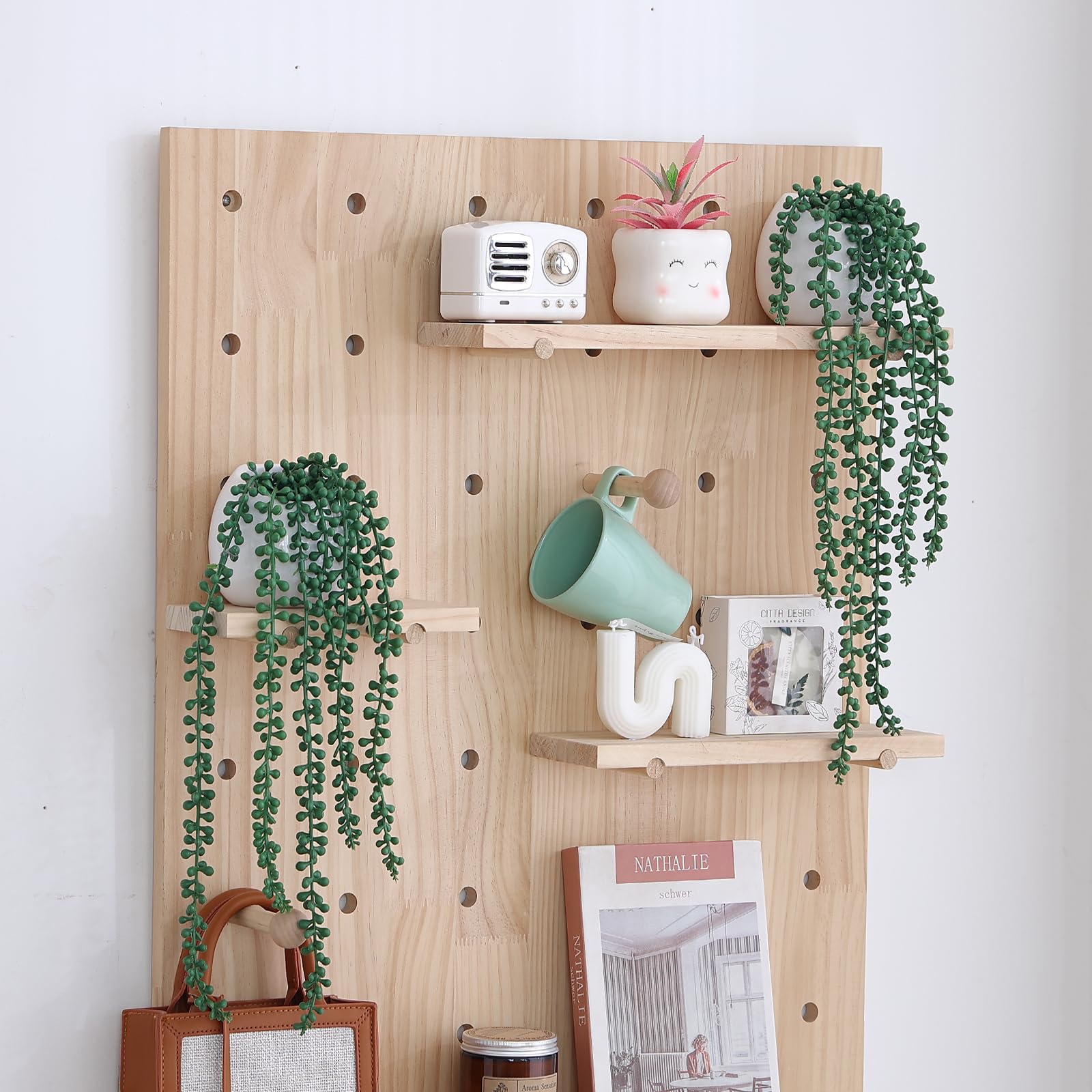Tiita size comparison next to a book and mug demonstrating compact pots and long strands