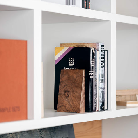 TILISMA bookend next to hand and ruler showing compact size