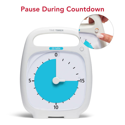 TIME TIMER beside a notebook showing compact size and convenient placement