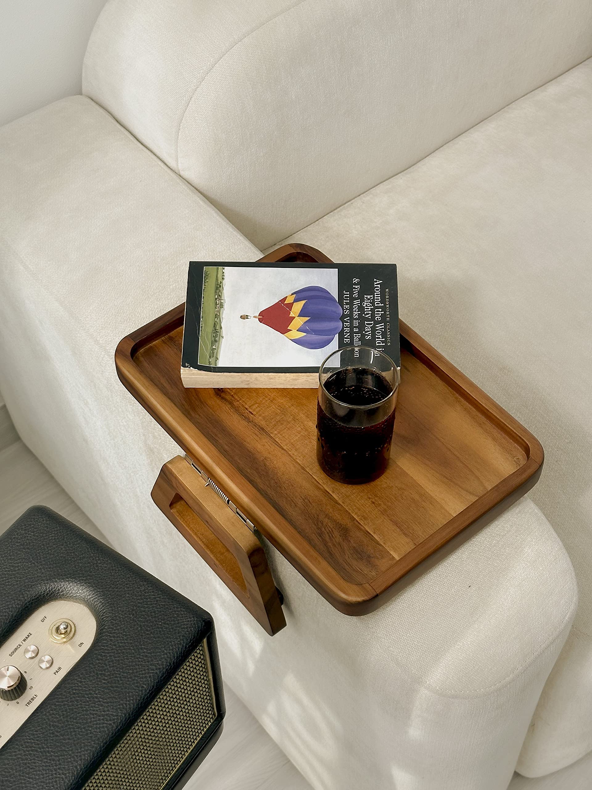 Tinamo in living room lifestyle shot holding laptop and coffee, enhances everyday comfort