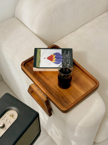 Tinamo in living room lifestyle shot holding laptop and coffee, enhances everyday comfort