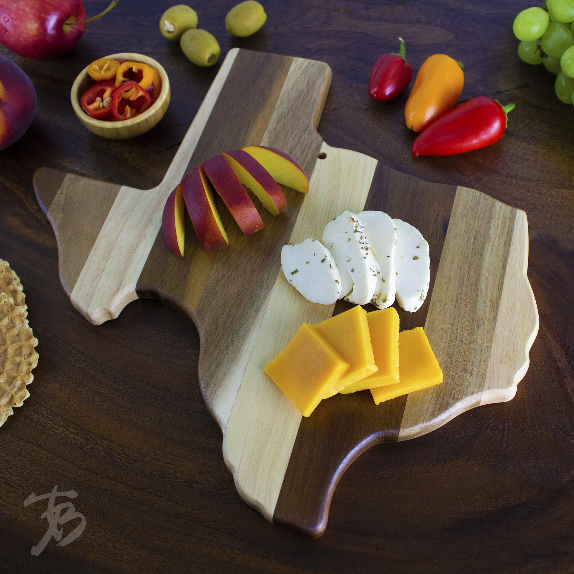 Totally Bamboo board next to a dinner plate to show 13 by 12.5 inch scale