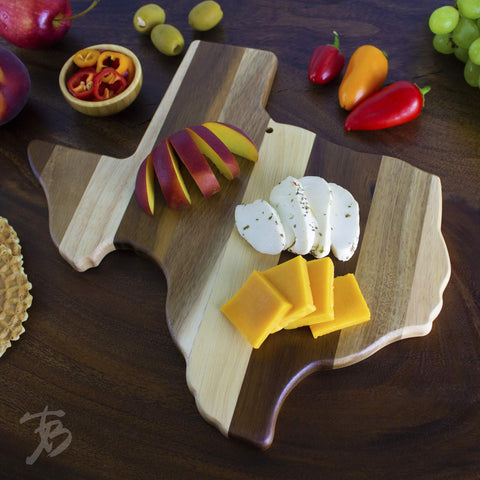 Totally Bamboo board next to a dinner plate to show 13 by 12.5 inch scale