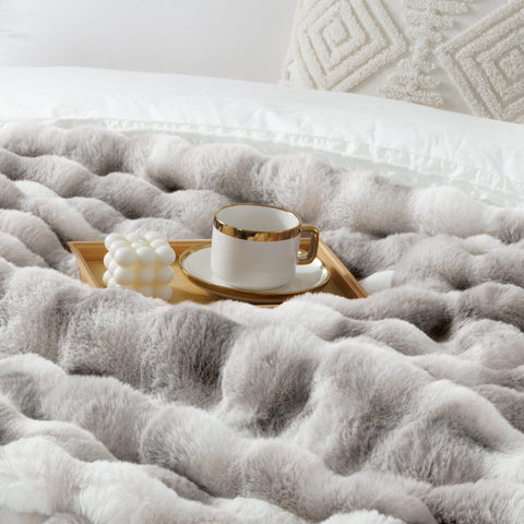 Touchat hands pressing plush pile showing tactile softness and comfort benefit