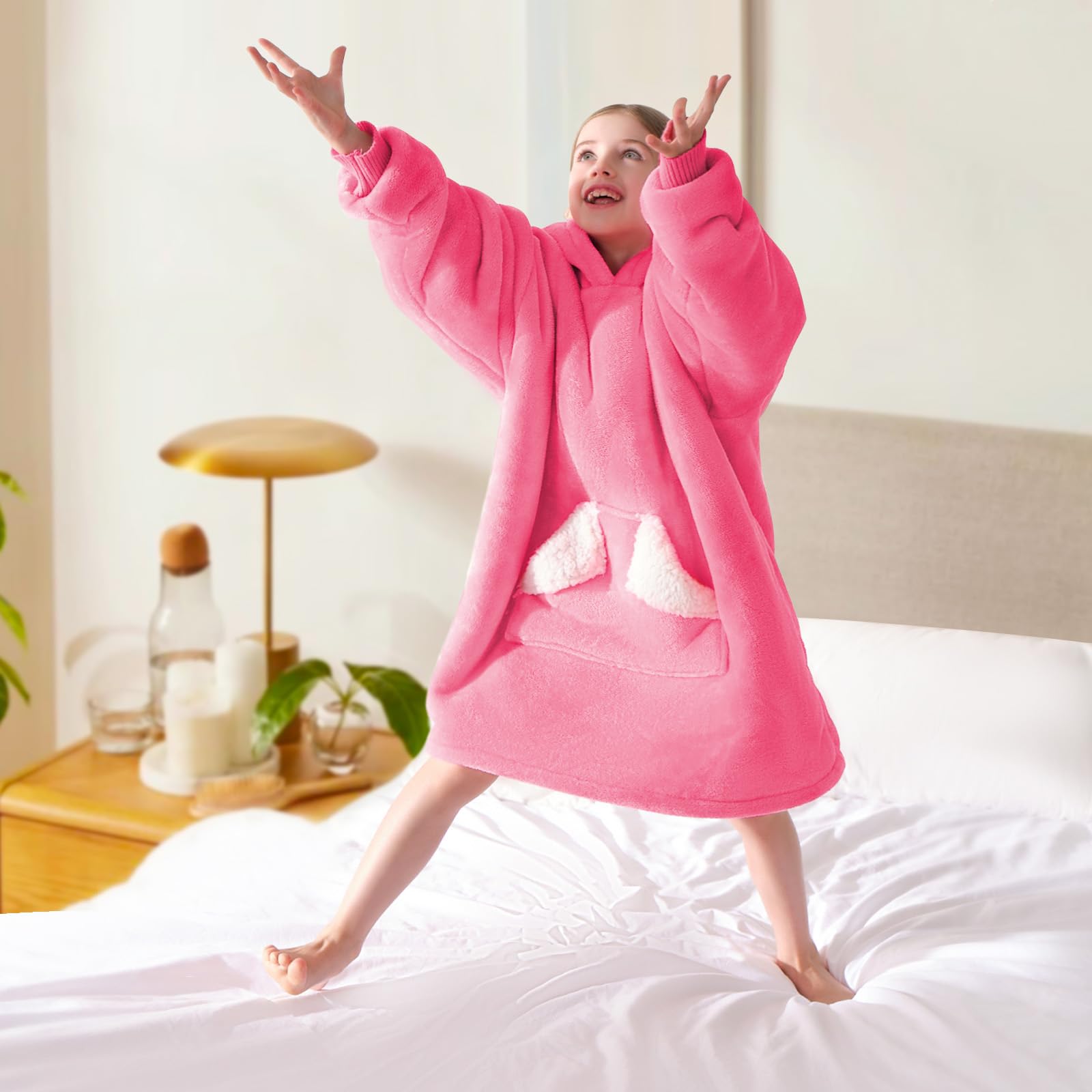 Touchat lifestyle image in bedroom showing cozy hooded blanket for sleepovers