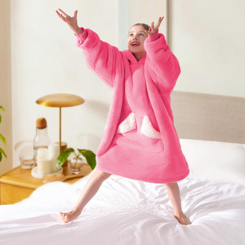 Touchat lifestyle image in bedroom showing cozy hooded blanket for sleepovers