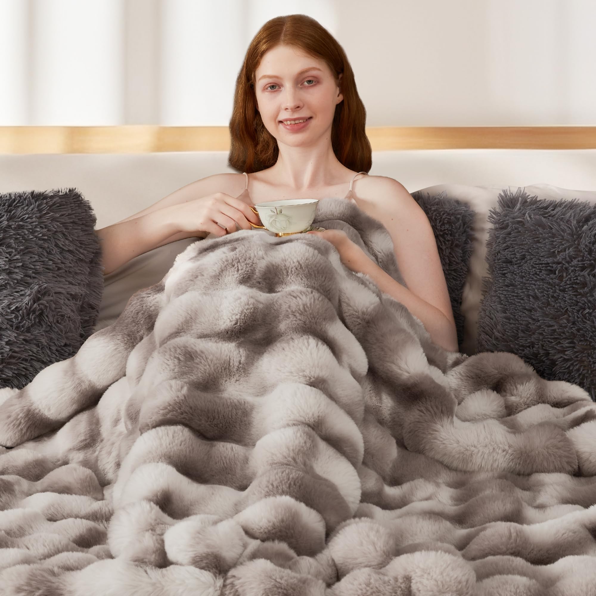 Touchat draped over bed footboard demonstrating cozy bedroom warmth benefit
