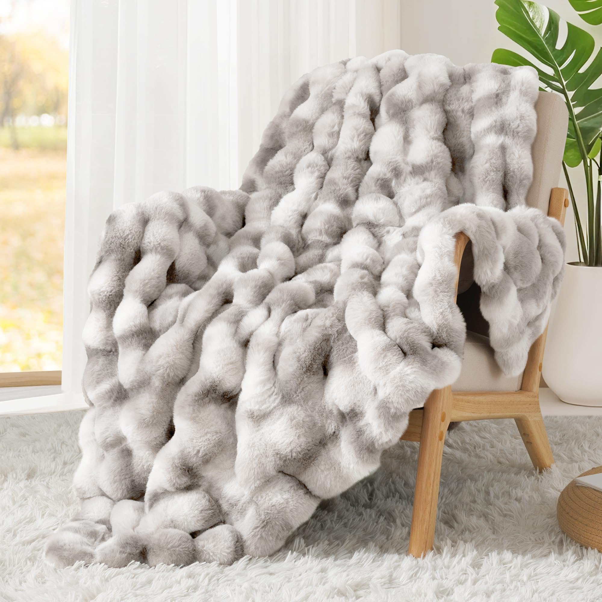 Touchat blanket next to couch to show scale and generous coverage benefit