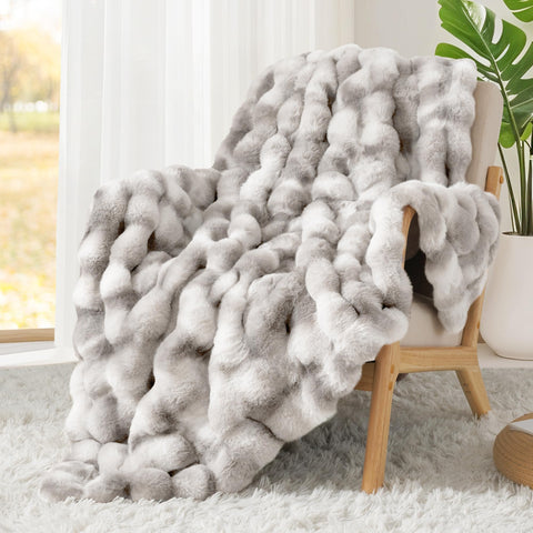 Touchat blanket next to couch to show scale and generous coverage benefit