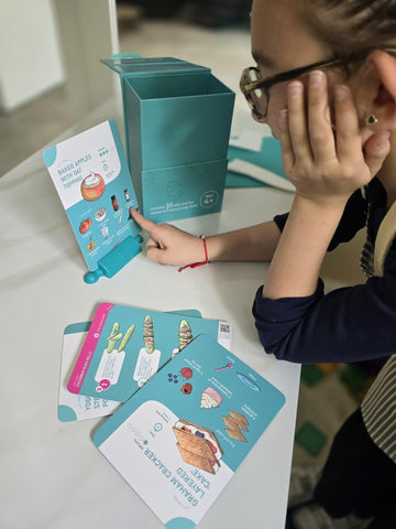 TOVLA JR size comparison with hand demonstrates compact, child-friendly card dimensions