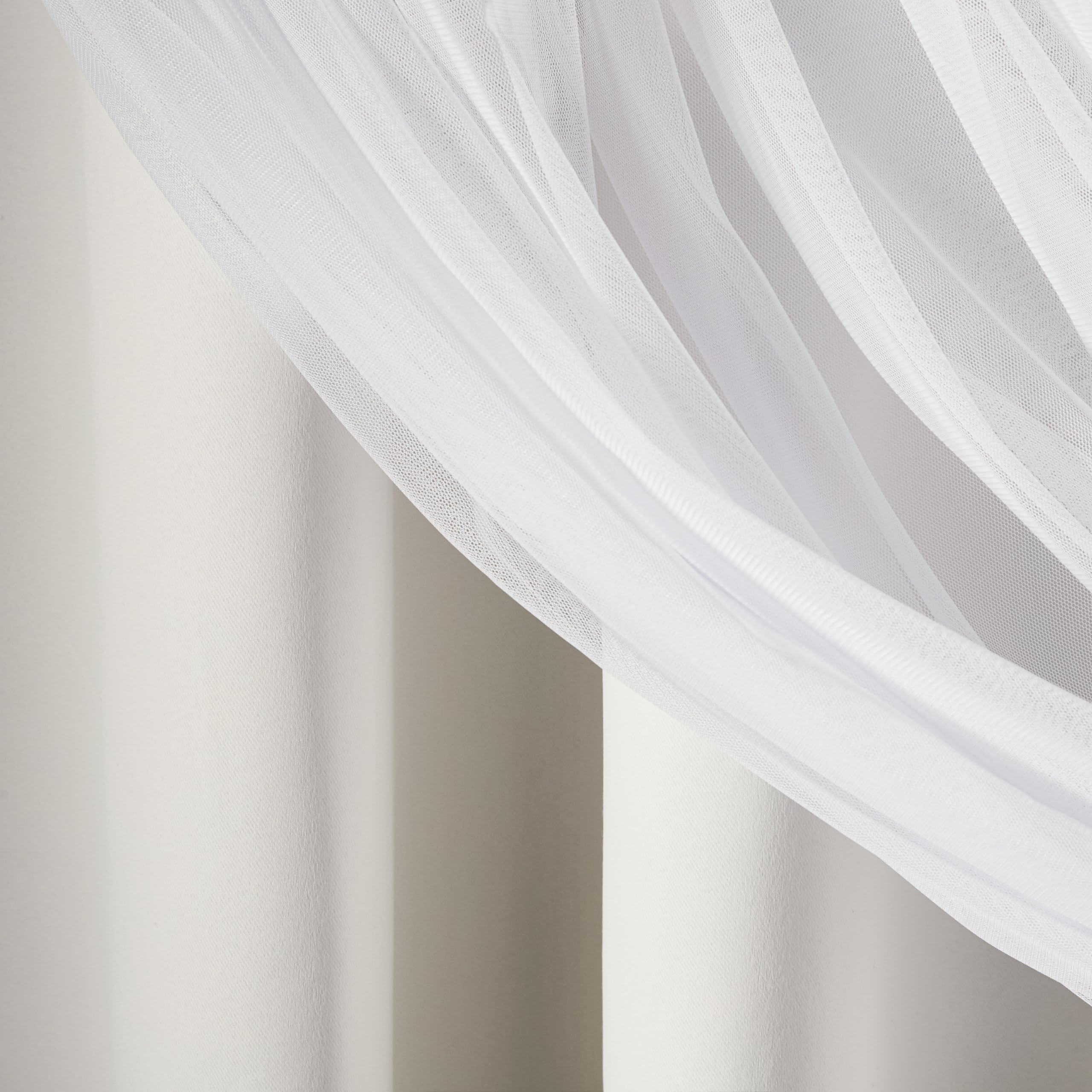 TOWN & COUNTRY LUXE curtain next to chair for scale showing full-length coverage benefit