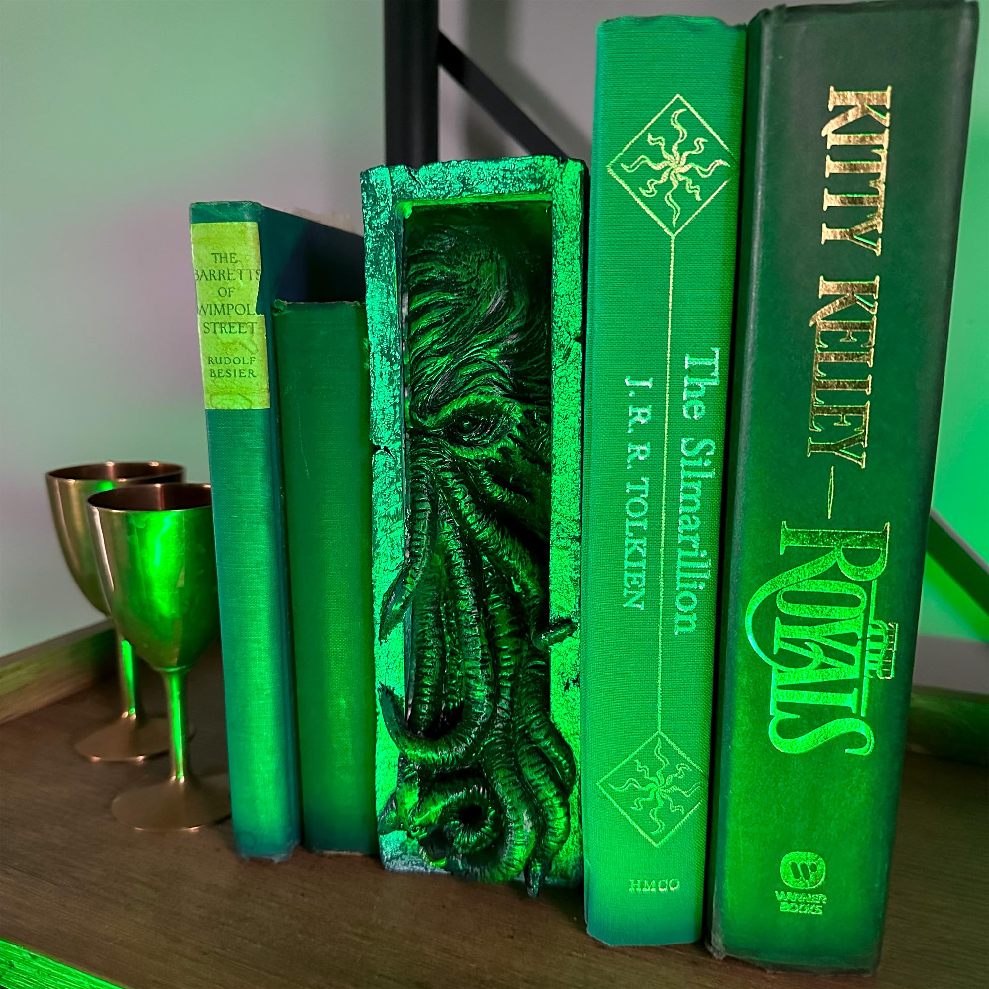 Toy Vault Peeping Cthulhu nestled between books showing shelf-ready aesthetic