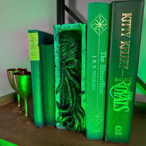 Toy Vault Peeping Cthulhu nestled between books showing shelf-ready aesthetic