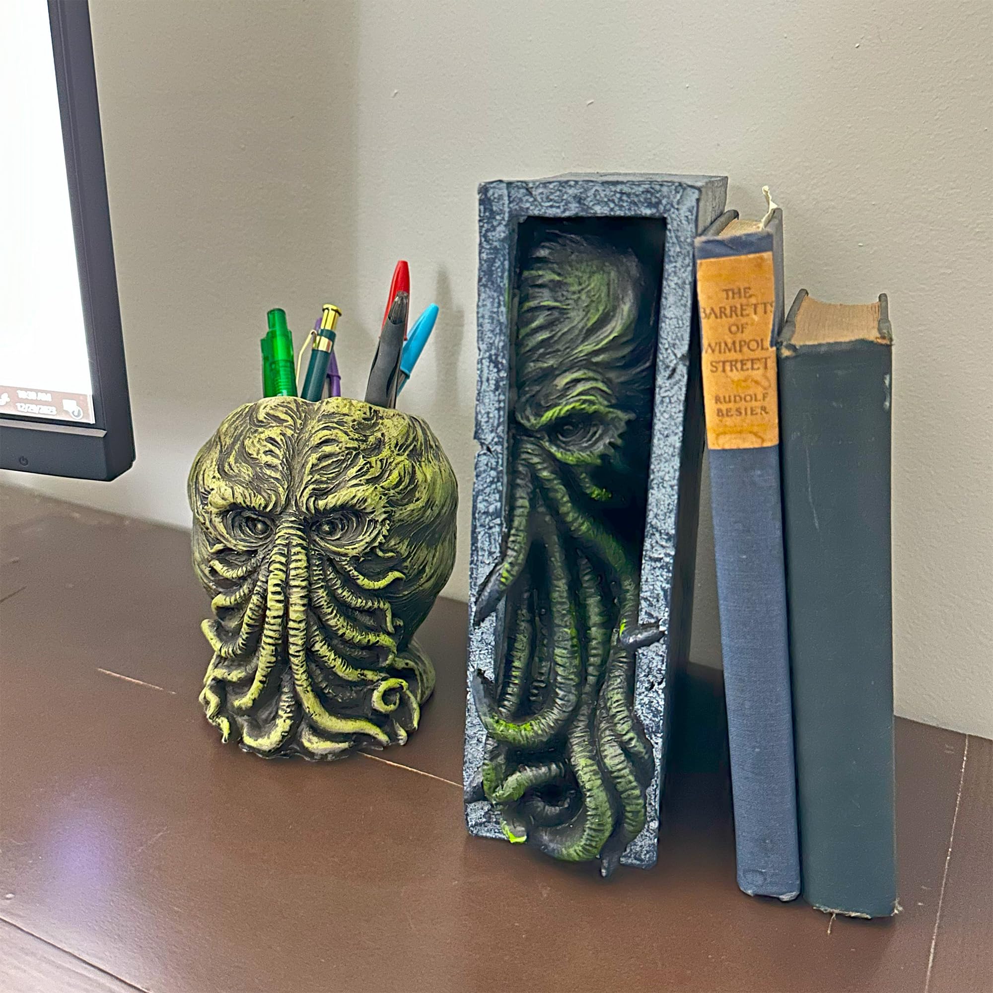 Toy Vault Peeping Cthulhu acting as bookend stabilizing paperbacks with style