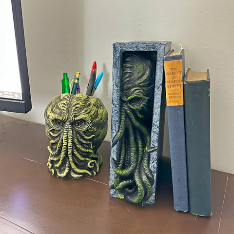 Toy Vault Peeping Cthulhu acting as bookend stabilizing paperbacks with style