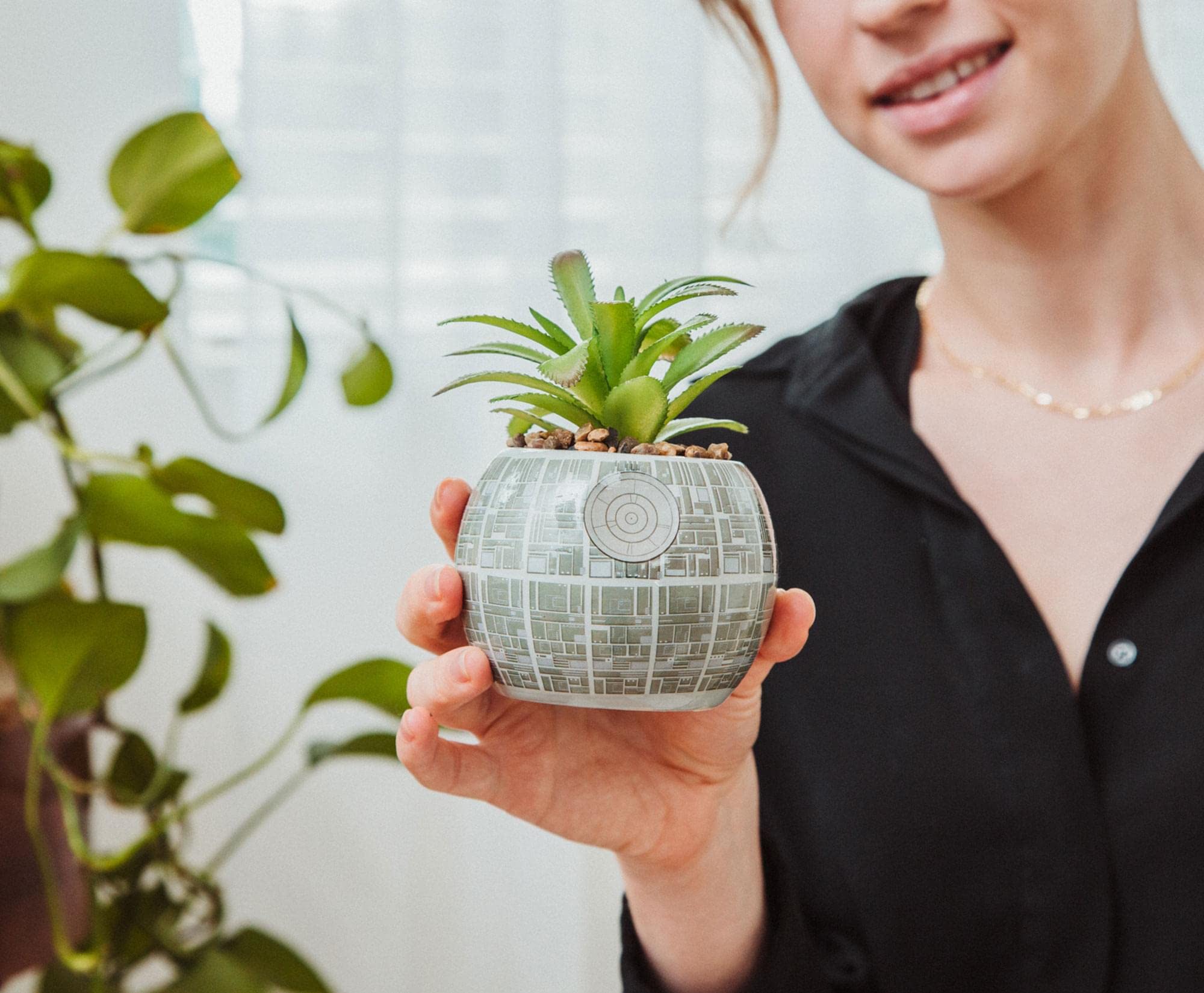 Toynk Death Star planter beside coffee mug showing compact size for small spaces