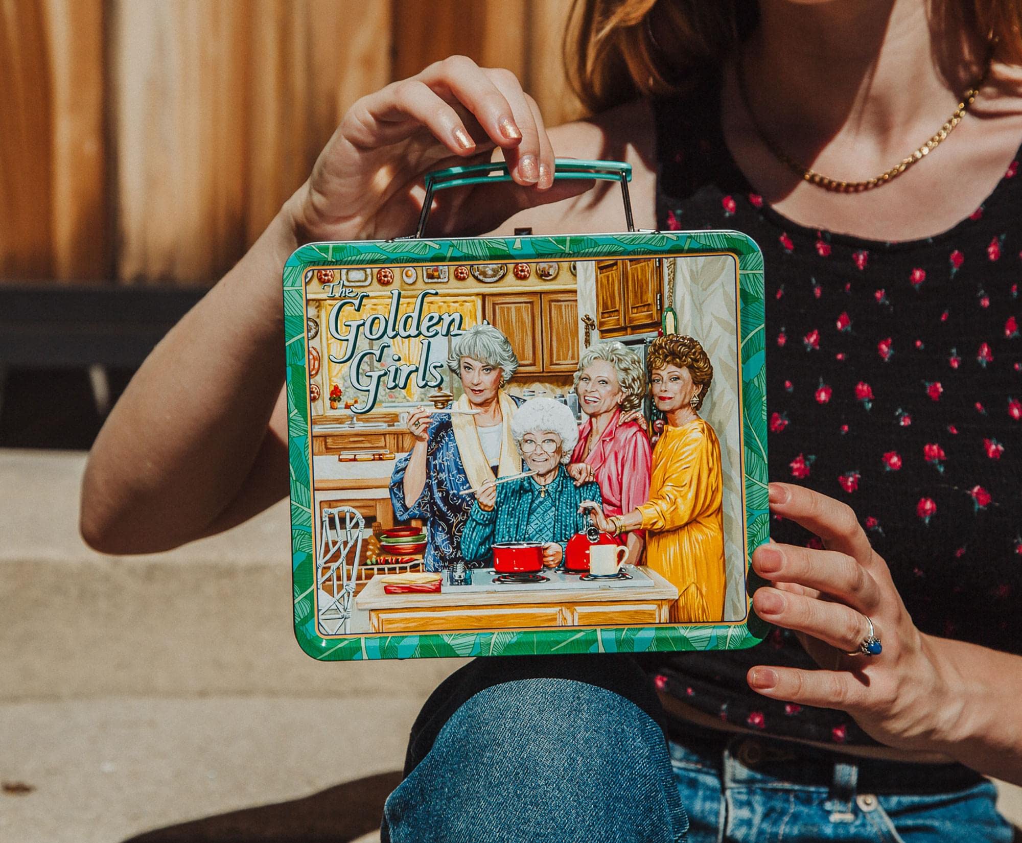 Toynk Golden Girls next to a notebook to show size and portability benefit
