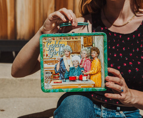 Toynk Golden Girls next to a notebook to show size and portability benefit