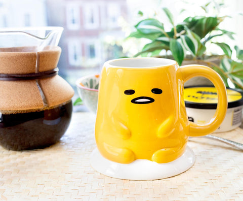 Toynk Gudetama beside measuring cup illustrating true 20oz capacity clarity