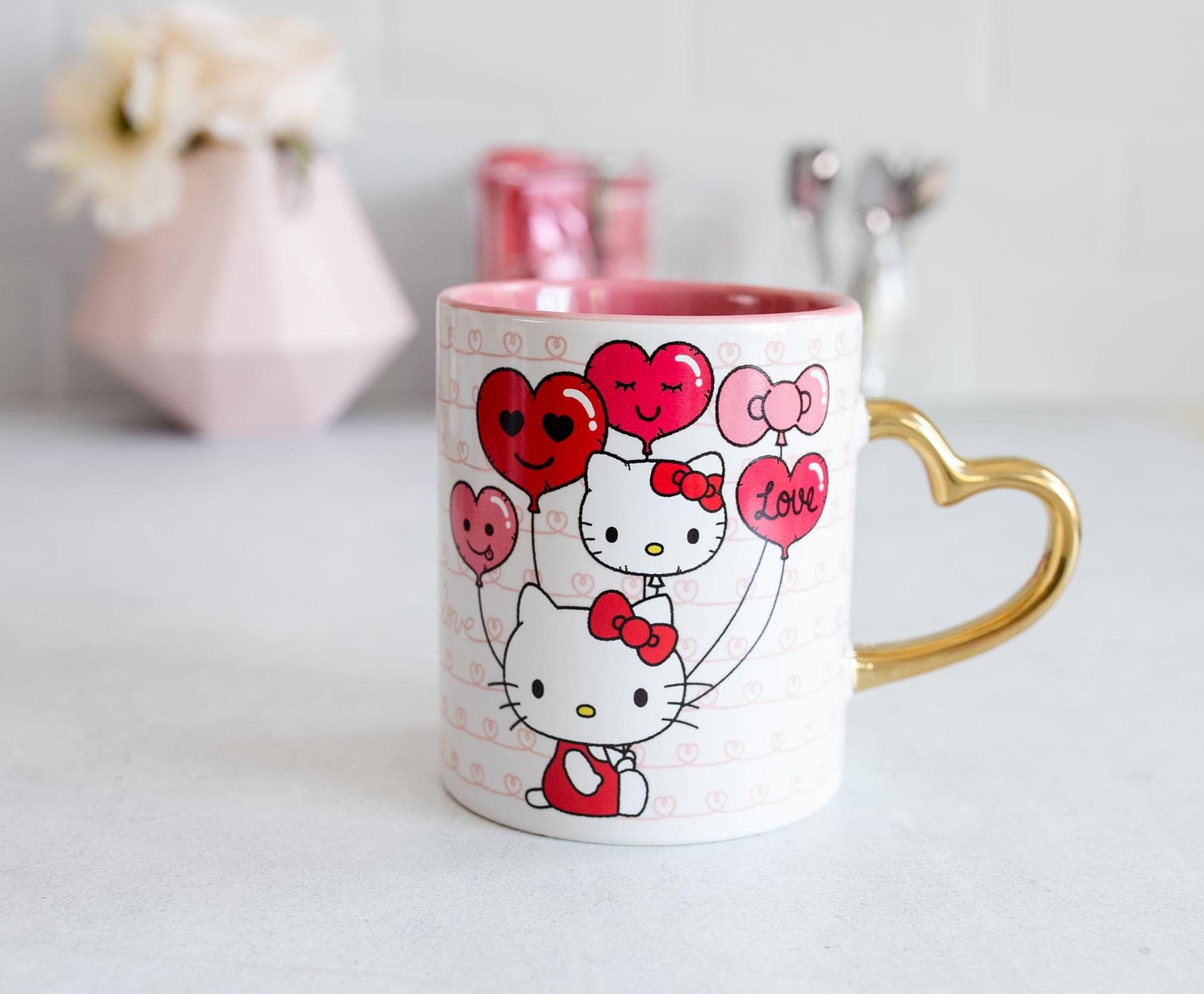 Toynk Hello Kitty beside a 14 oz scale to illustrate mug size and serving