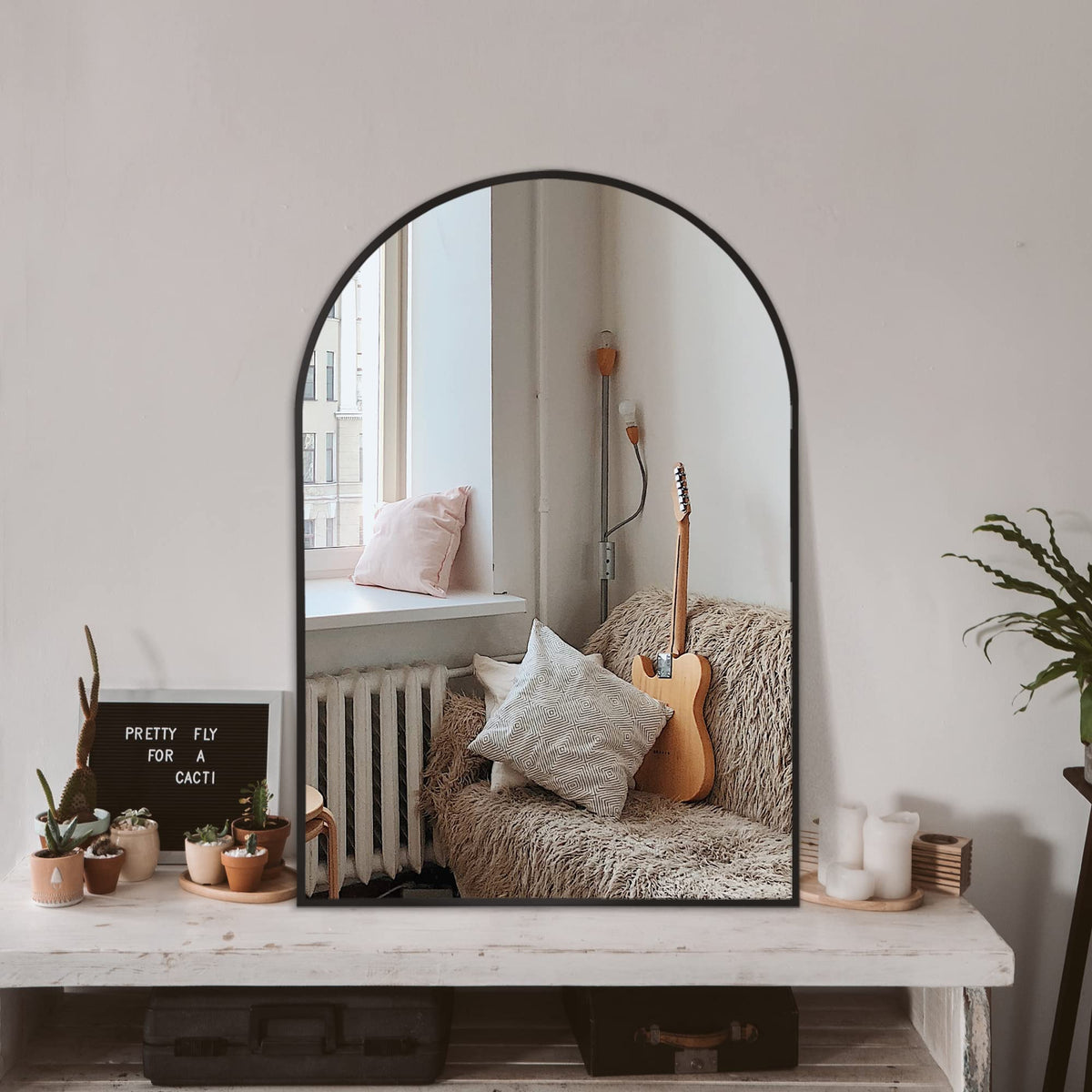 TRAHOME arched mirror front view showing sleek matte black frame and balanced proportions