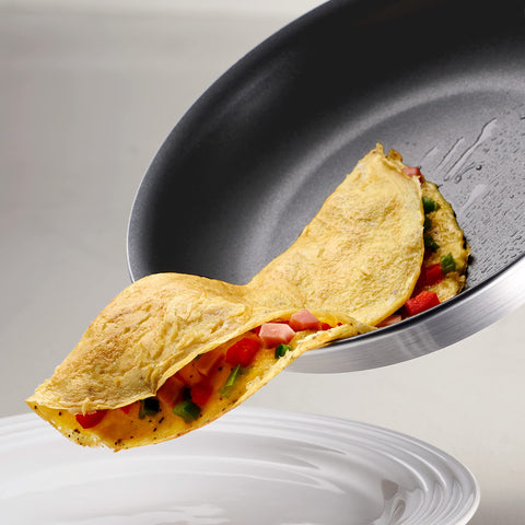 Tramontina pan beside cookware ruler to illustrate its 10-inch cooking surface