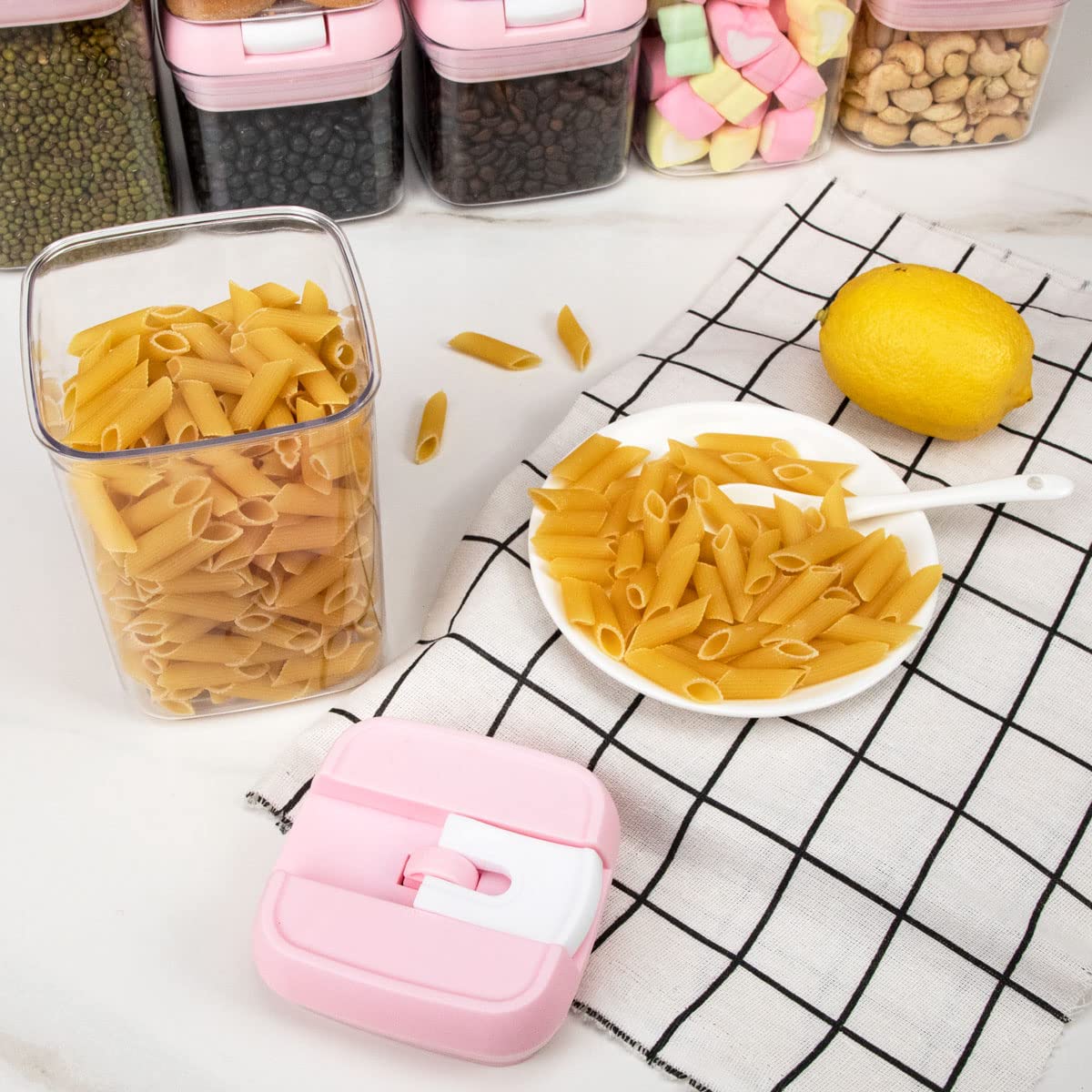 U-QE canisters beside fruit for scale to show compact sizes and versatile storage capacity