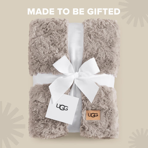 UGG Adalee spread on bed layered with pillows for elevated decor