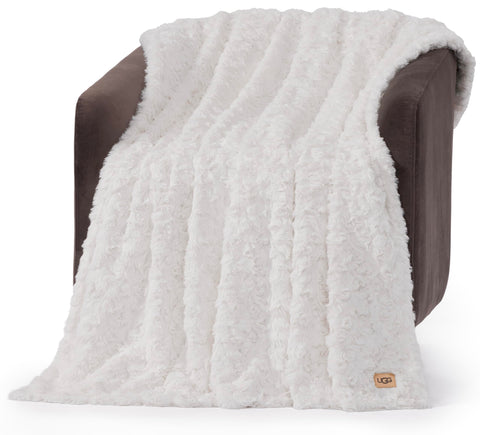 UGG Adalee front folded on couch showing clean white look and cozy appeal