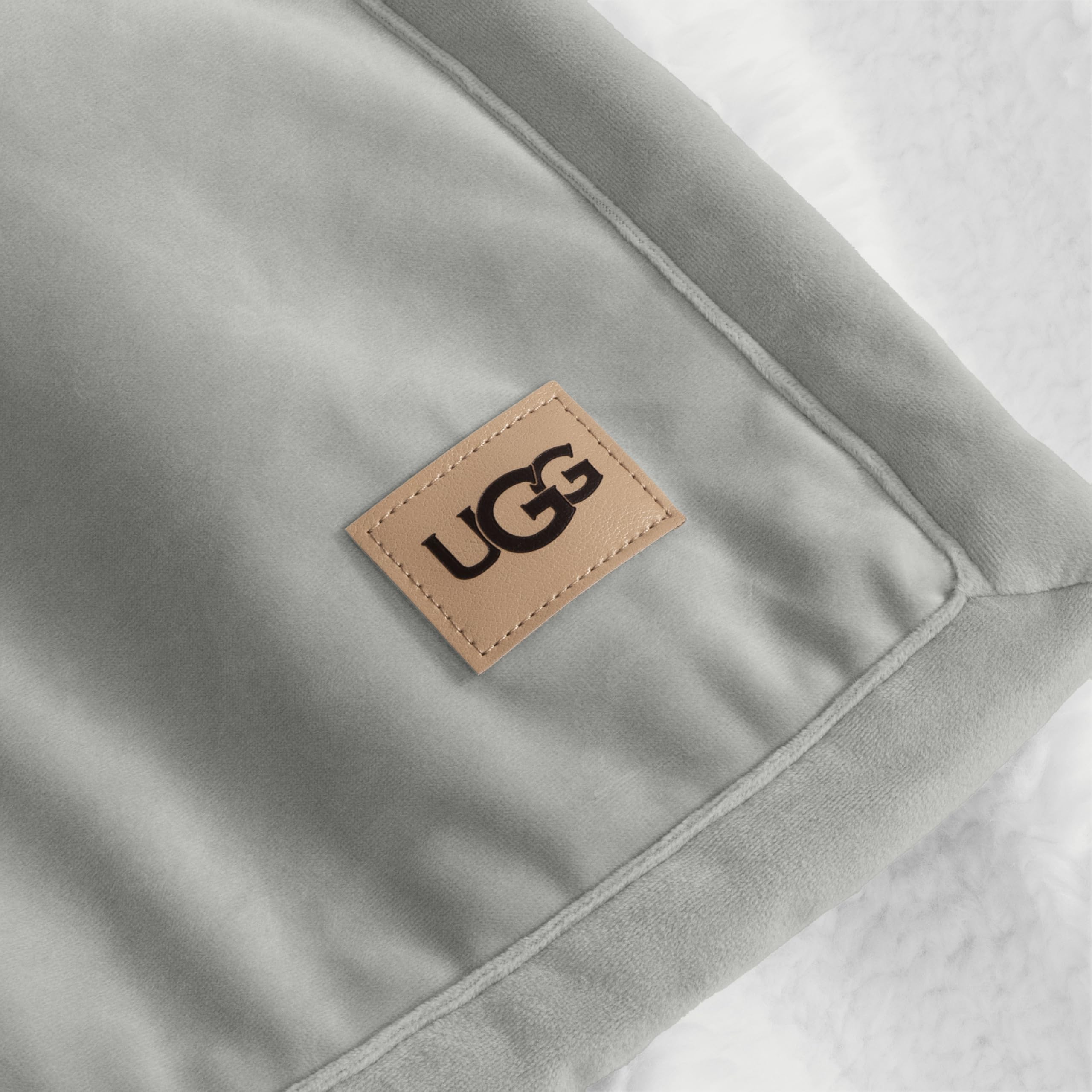 UGG Bliss size comparison on lap showing generous coverage benefit