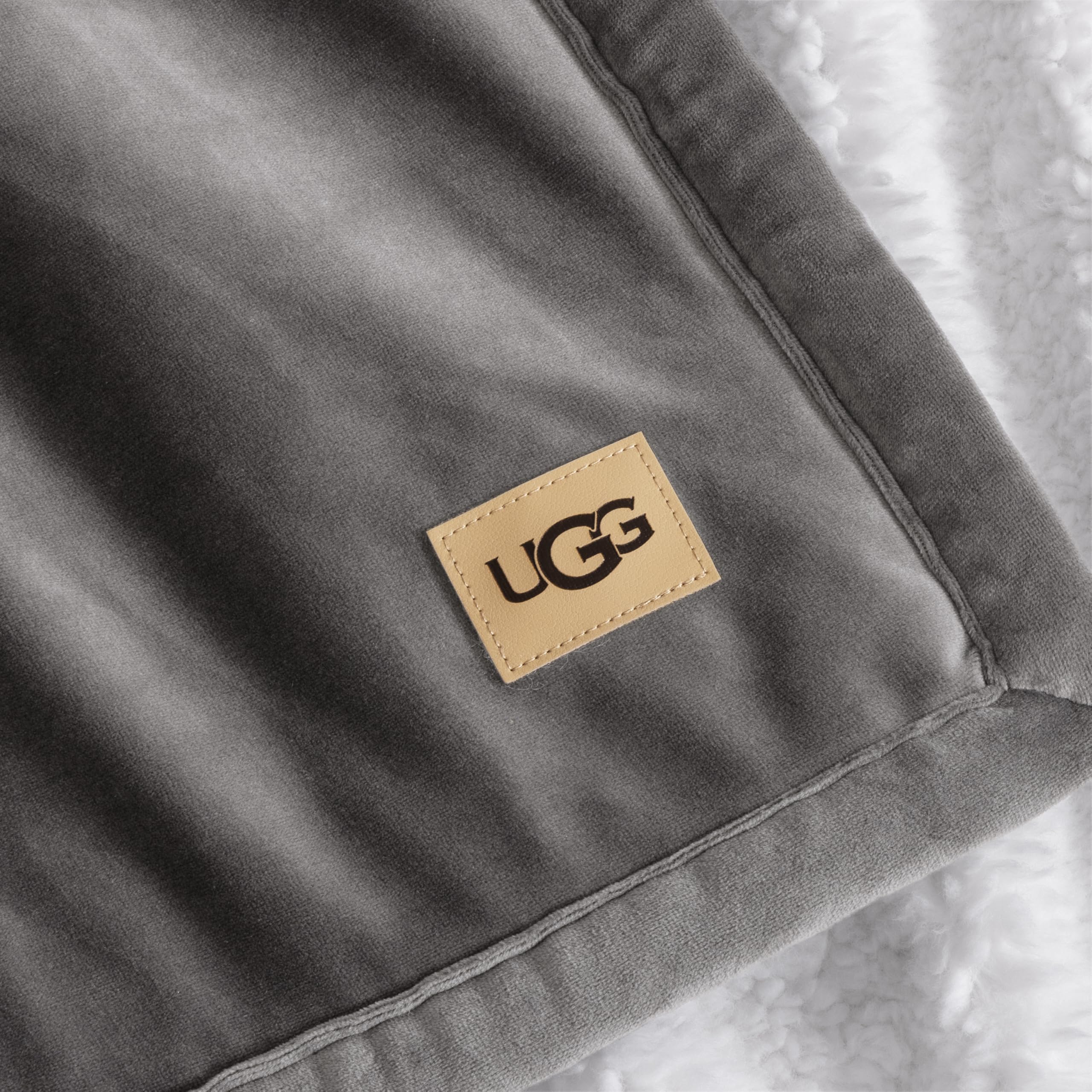 UGG layered at foot of bed offering stylish warmth and bedroom depth