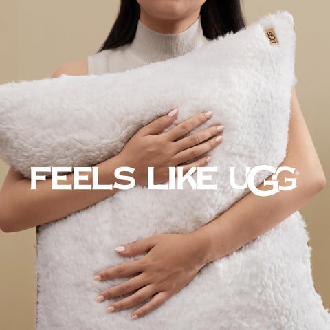 UGG comforter on bed showing size and generous overhang for queen mattress