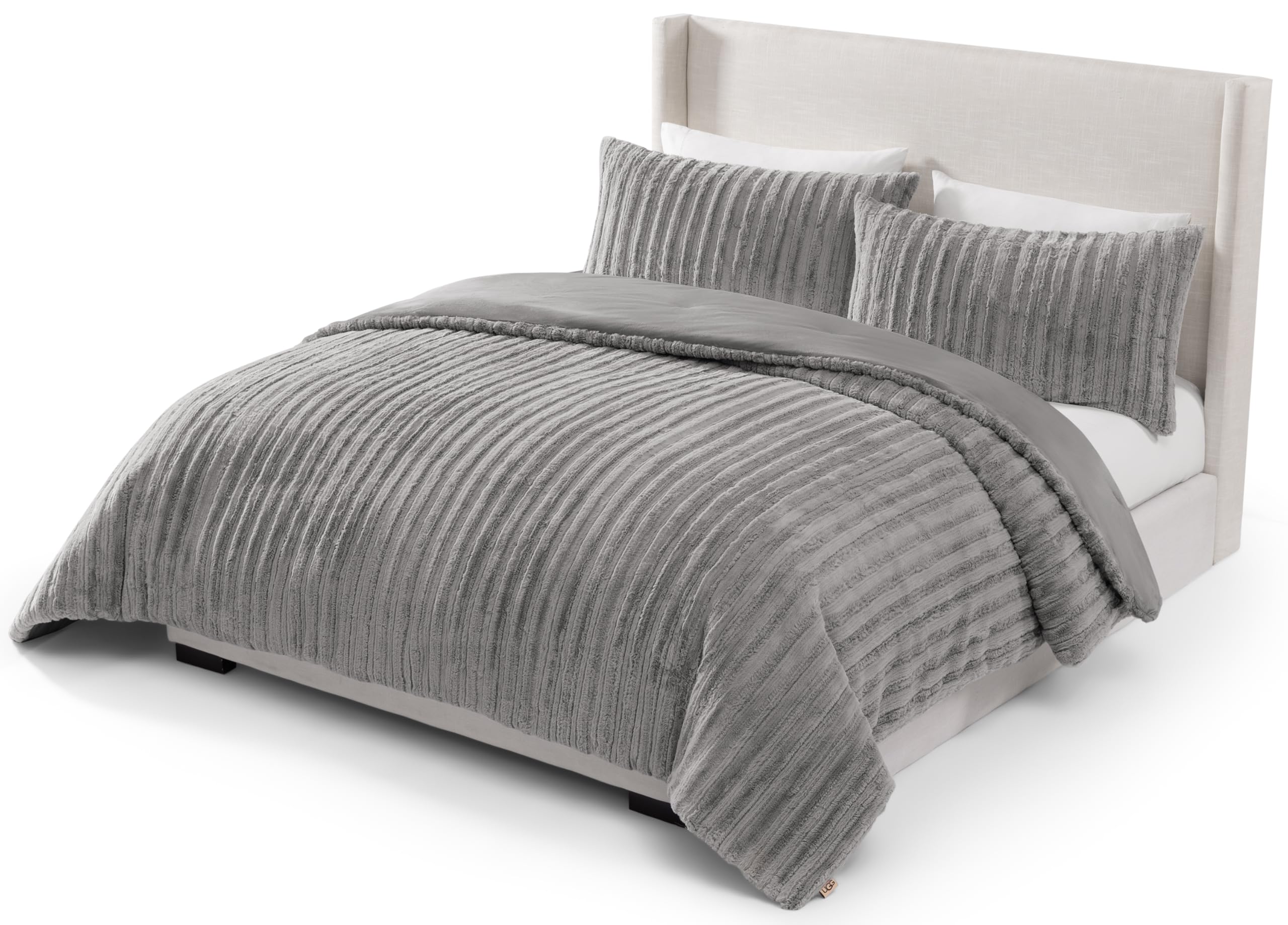 UGG Kenzie front view on bed showing plush grey fur and cozy appeal