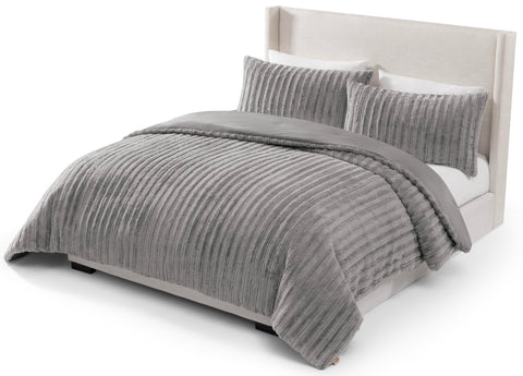 UGG Kenzie front view on bed showing plush grey fur and cozy appeal