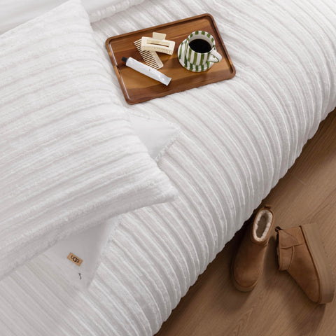 UGG Kenzie on queen bed demonstrating generous drape and proper size fit