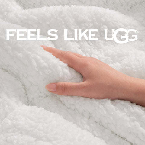 UGG Nita draped over bed demonstrating full-size coverage and warmth