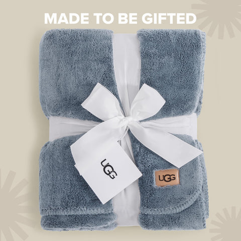 UGG Whitecap draped over sofa showing visual warmth and decorative layering