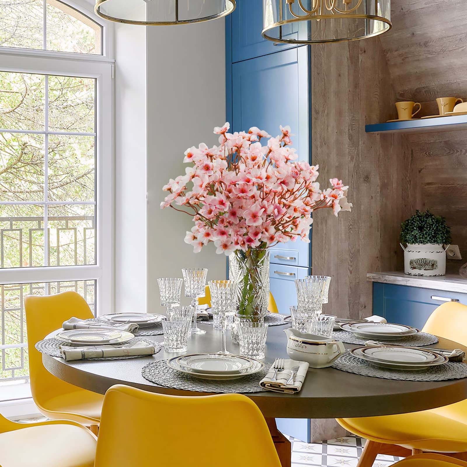 Uieke floral arrangement in vase on dining table adding lasting pink accent to interiors