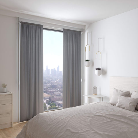Umbra curtain held flush against wall reducing light gaps for darker room